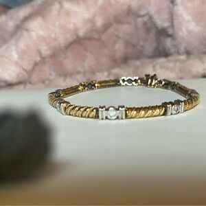 White Gold and yellow Gold round cut diamond station set bracelet.